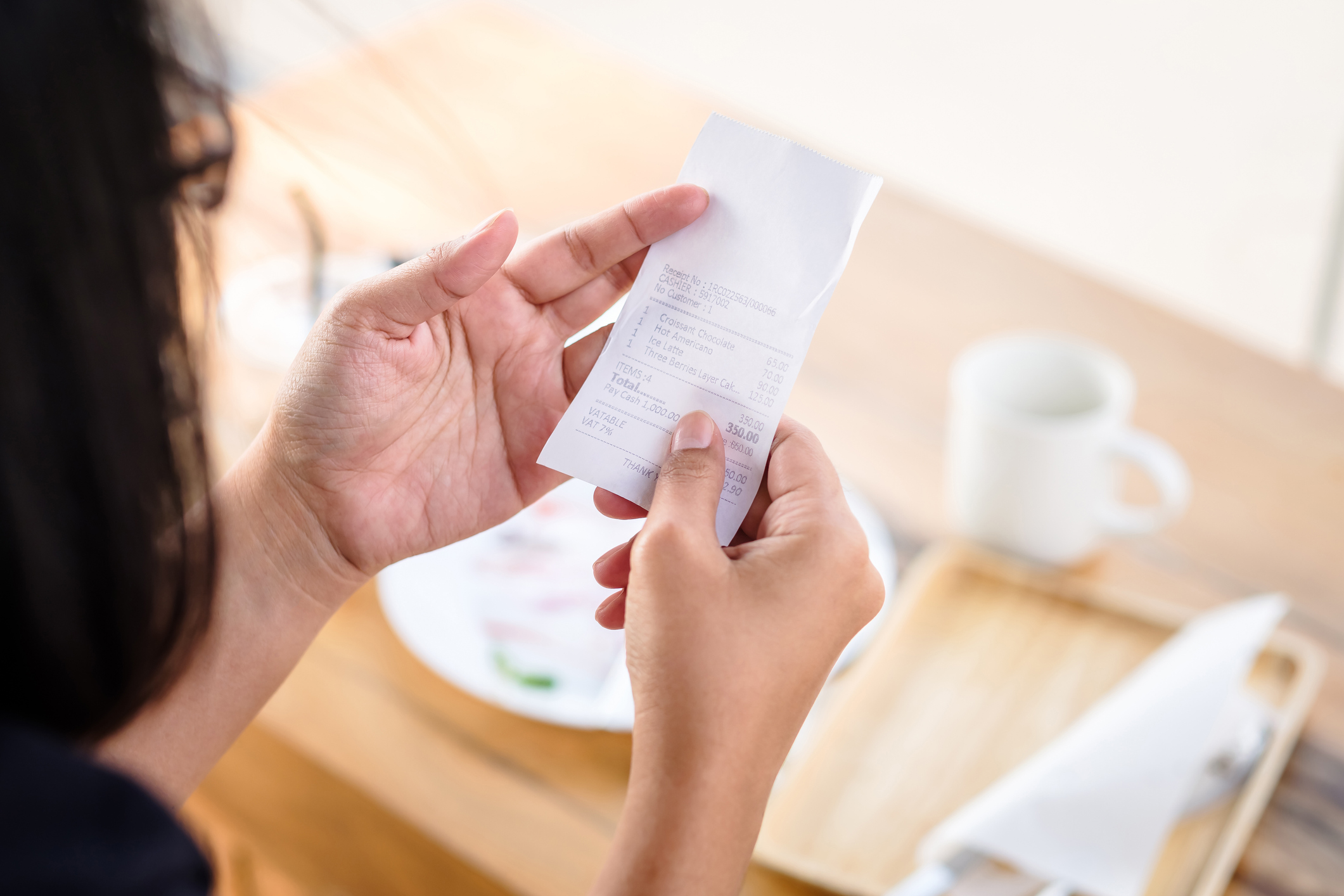 person looking at receipt